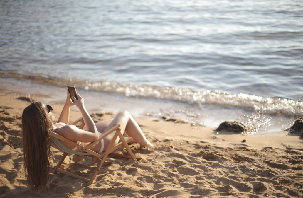 woman-in-white-bikini-lying-on-beach-chair-on-beach