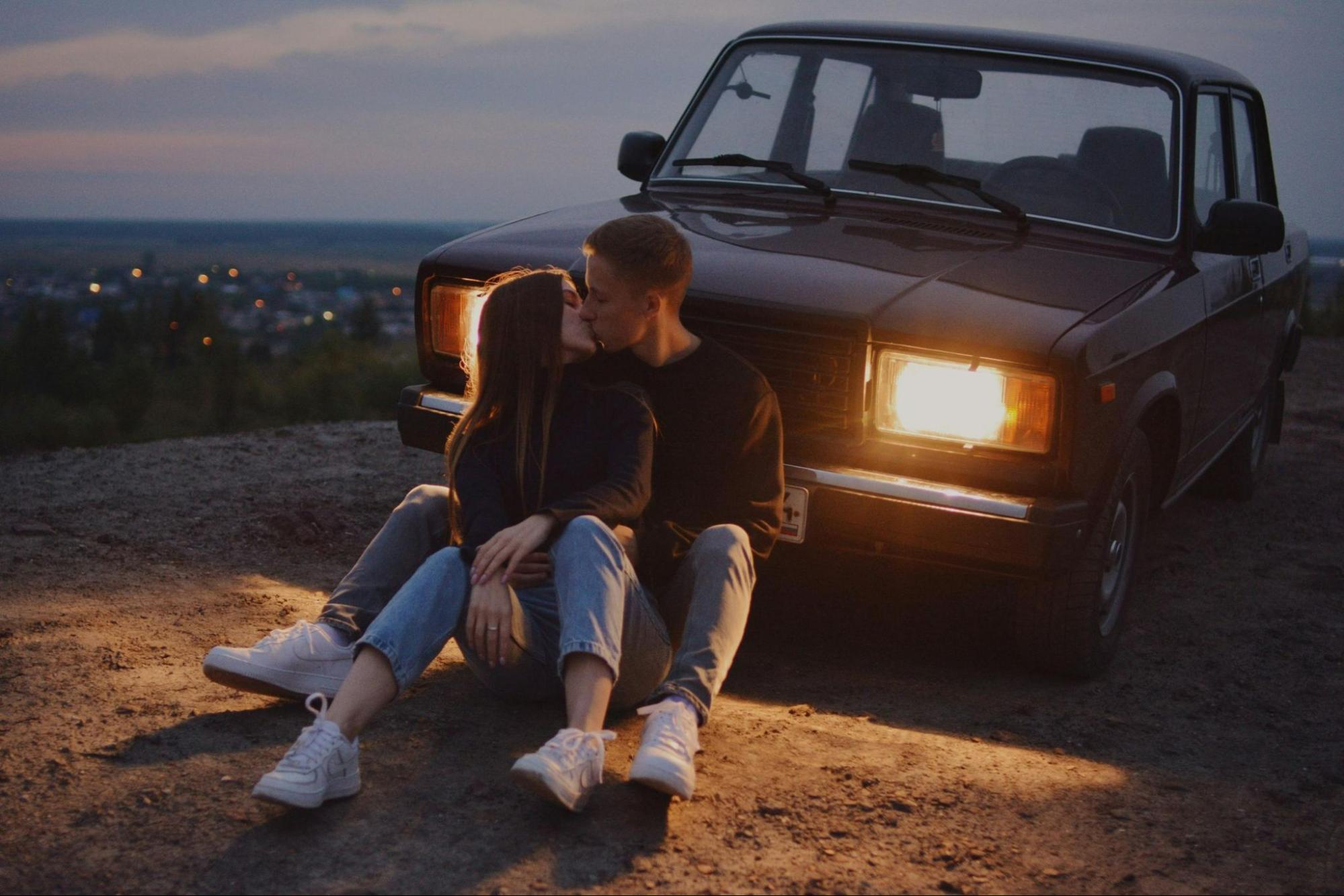 photograph-of-a-couple-kissing-in-front-of-a-car