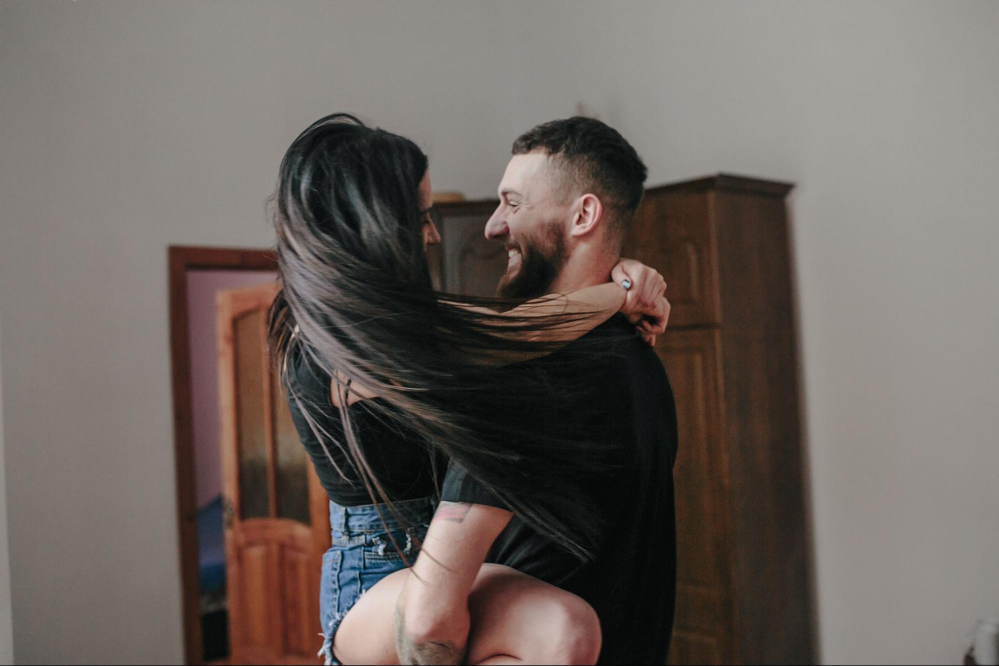 Woman in happy relationship hugging smiling boyfriend