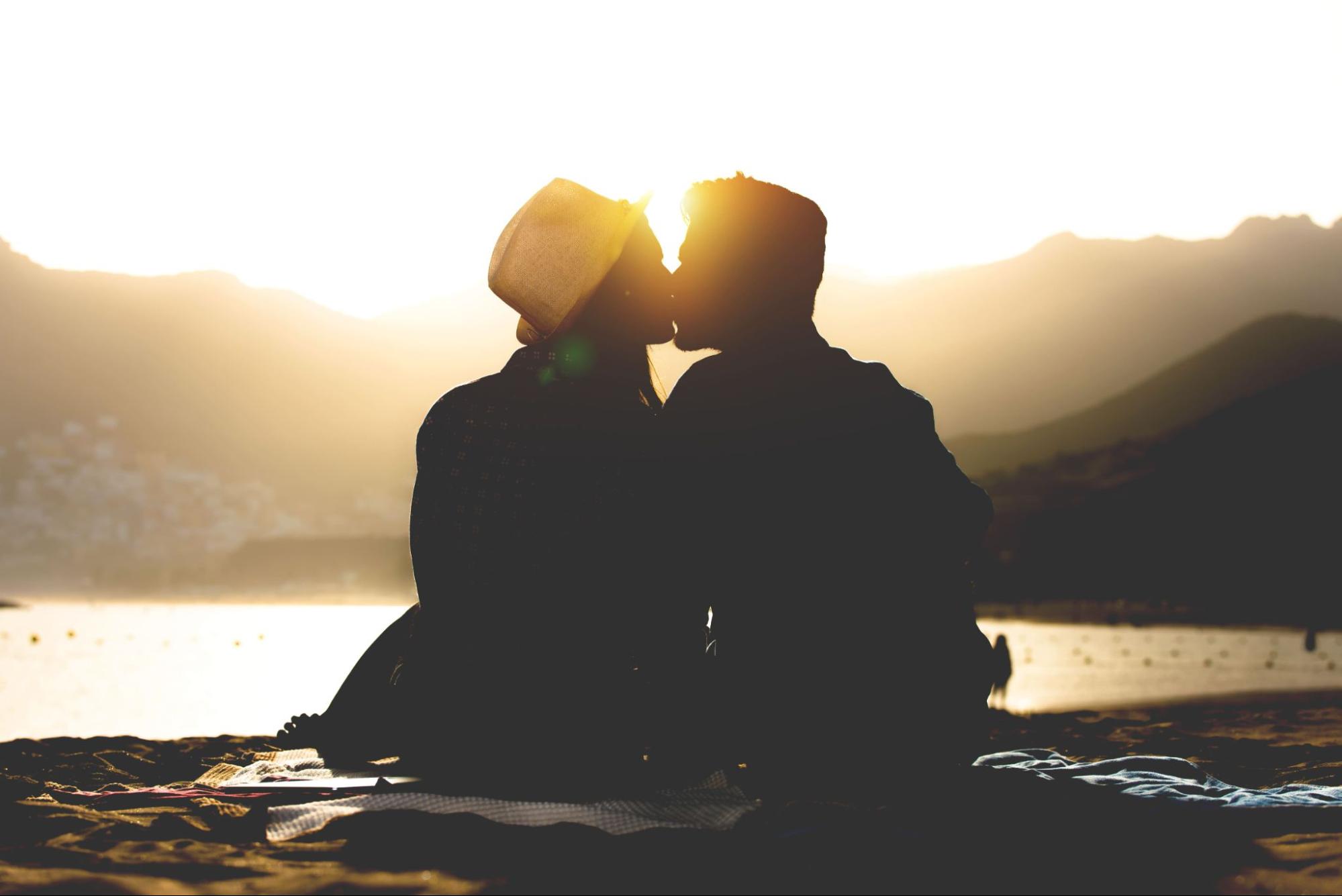 man and woman on date outside watching sunset