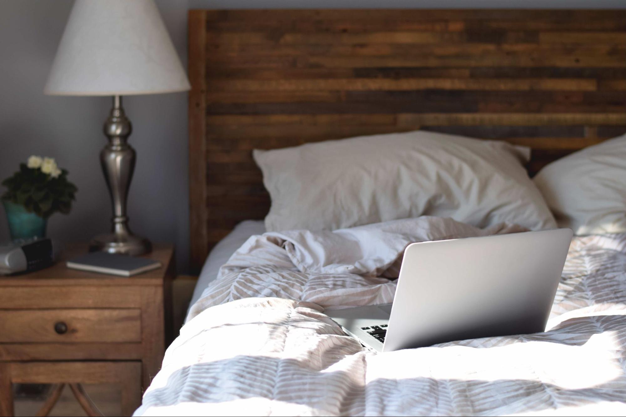 empty bed with laptop