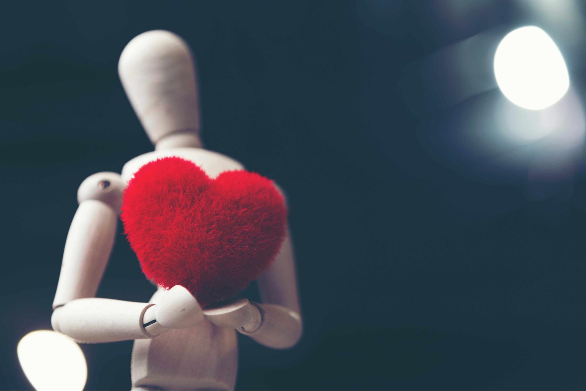 ai girlfriend type figure trying to give heart to real person