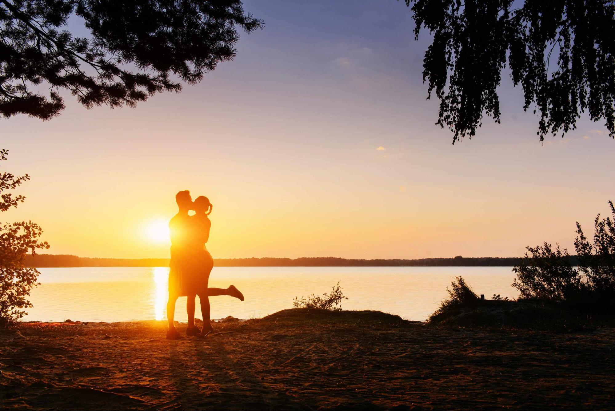 happy couple who met on real dating app hugging at sunset